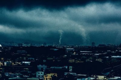 City buildings against cloudy sky