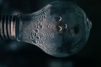 Close-up of bubbles in glass against black background