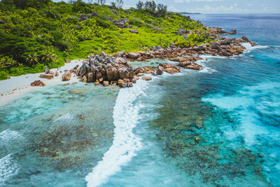 Scenic view of rocks on beach against sky