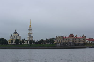 Buildings at waterfront against sky