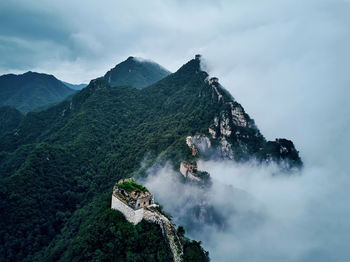 Great of wall china and mountains against cloudy sky