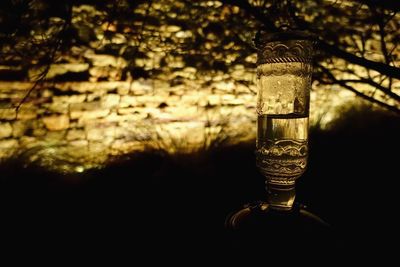Close-up of lit lamp in darkroom