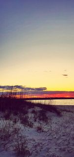 Scenic view of beach against sky during sunset