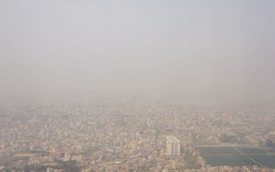 High angle view of city buildings against clear sky