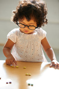 High angle view of girl drawing on table