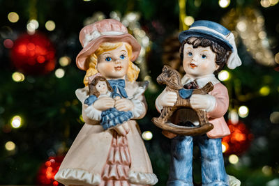 Close up of vintage ornaments in front of christmas tree christmas tree