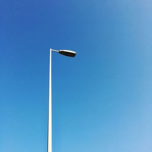 Low angle view of basketball hoop against clear blue sky