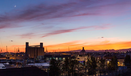 High angle view of illuminated buildings against sky during sunset