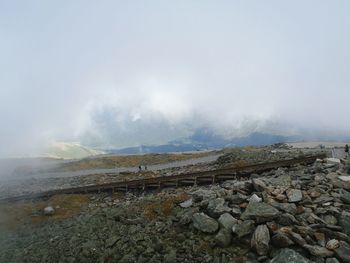 Scenic view of landscape against cloudy sky