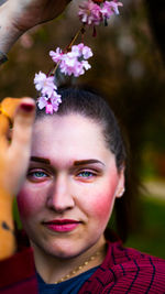 Close-up of young woman holding flowers