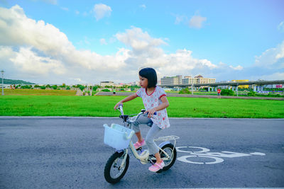 Young woman riding bicycle in park