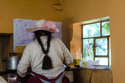 Midsection of woman standing against wall
