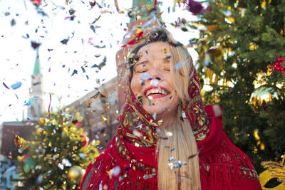 Portrait of woman with christmas tree