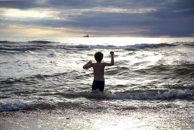 Man standing on beach against sky