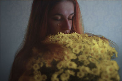 Close-up of young woman with flower bouquet