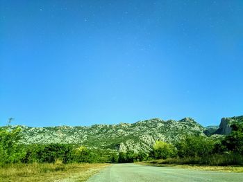 Scenic view of field against clear blue sky