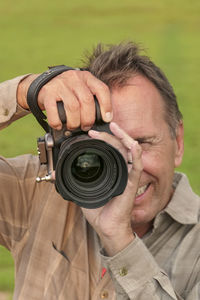 Close-up of man photographing with camera