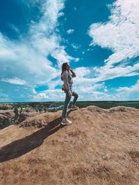 Woman standing on land against sky