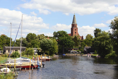 Boats moored at harbor on river