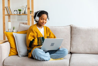 Young woman using laptop at home