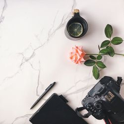 High angle view of flower and objects on marble