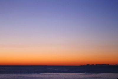 Scenic view of sea against romantic sky at sunset