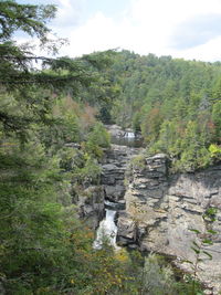 Scenic view of waterfall against sky