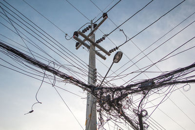 Low angle view of electricity pylon against sky