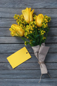 High angle view of yellow flower on table