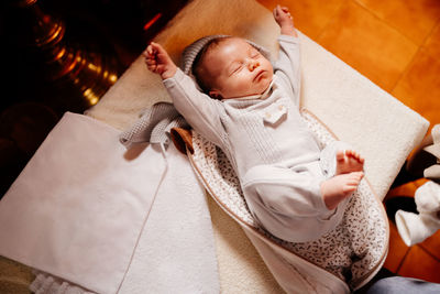 High angle view of baby sleeping in bed