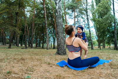 Mom and baby yoga outdoor classes. wellness, family yoga class, practicing mindfulness and