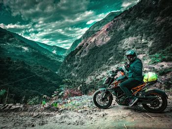 Man riding bicycle on mountain road