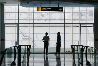 Friends standing at airport