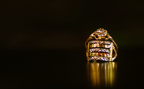 Close-up of illuminated lighting equipment against black background