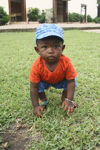 High angle view of boy sitting on field