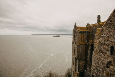 Scenic view of sea and building against sky