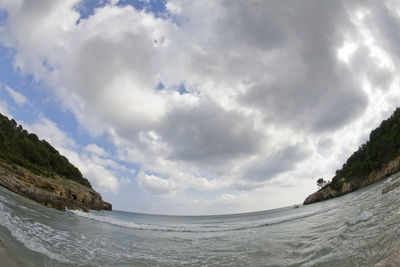 Panoramic view of sea and mountains against sky