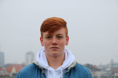 Portrait of teenage boy against sky