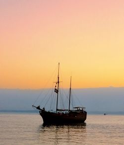 Sailboat on sea against sky during sunset