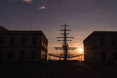 Low angle view of silhouette building against sky during sunset