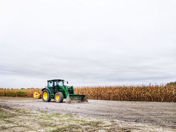 Tractor on field against sky