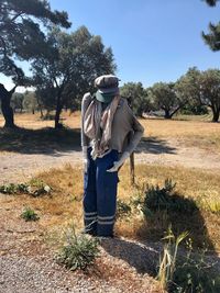 Scarecrow standing on the field against the sky 