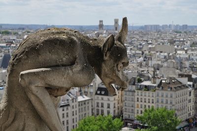 Close-up of sculpture against paris cityscape