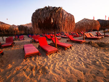 Panoramic view of chairs on beach against clear sky