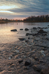 Scenic view of river against sky during sunset