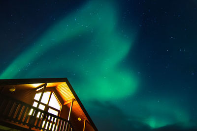 Low angle view of illuminated building against sky at night