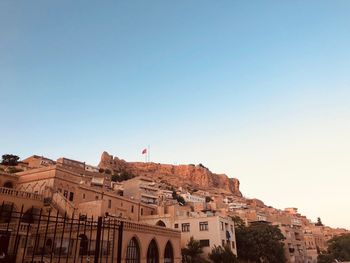 Low angle view of buildings against clear blue sky