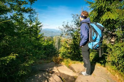 Full length of man standing against trees