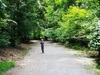 Rear view of woman walking on footpath