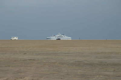 Nautical vessel on beach against clear sky